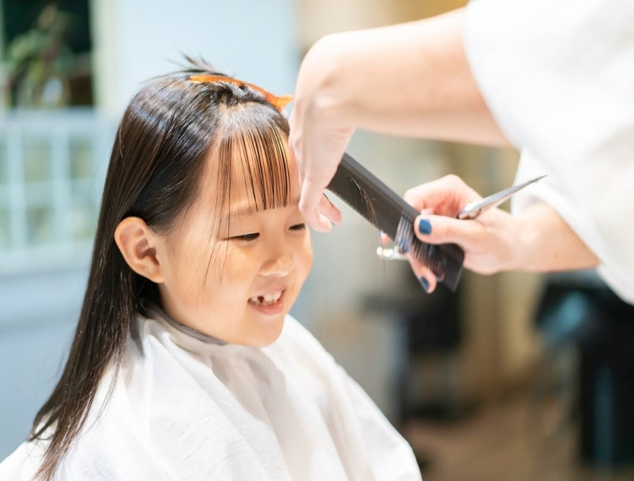 Child getting a summer haircut at StarKids Salon in Dubai