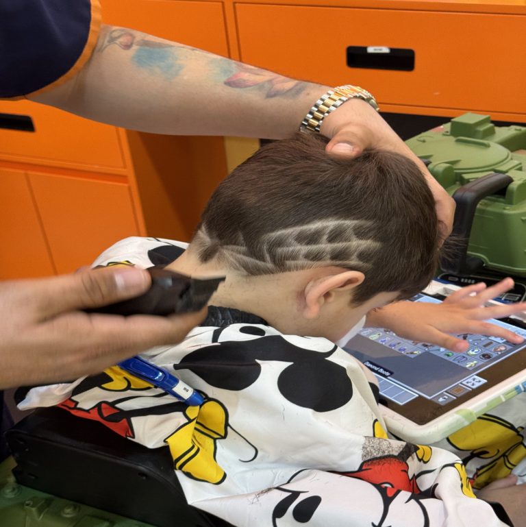 Child enjoying a fun haircut at StarKids Salon & Spa in Dubai