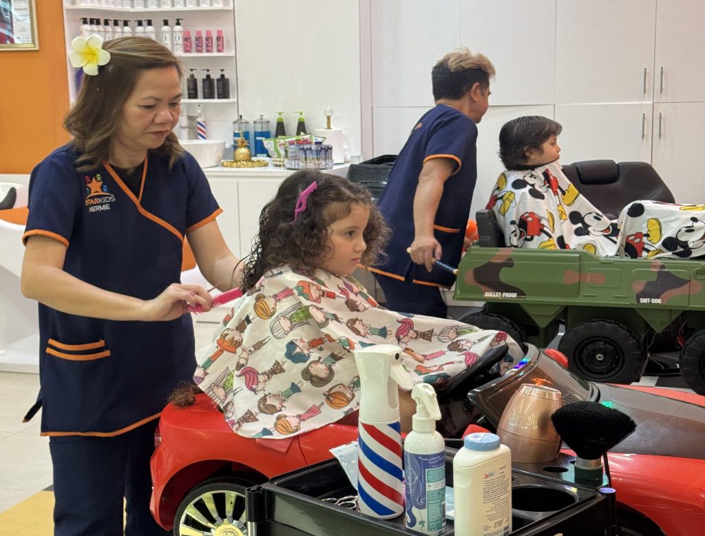 Cute child with freshly styled curly hair at kids salon in Dubai