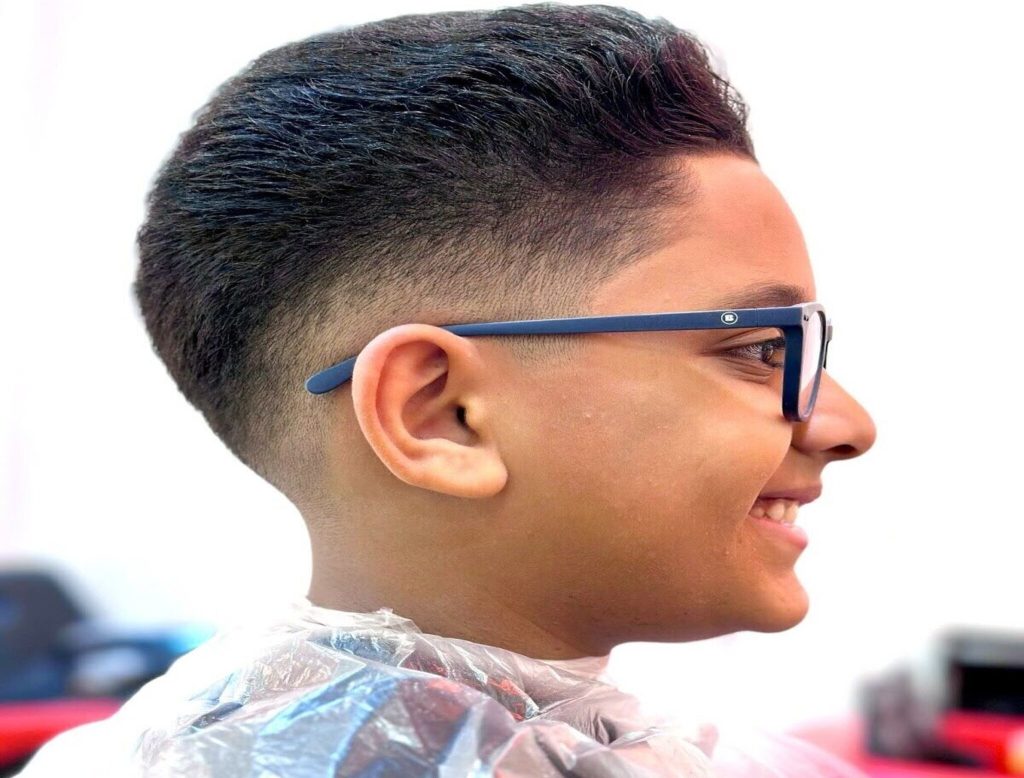 Happy child getting a stylish back-to-school haircut at StarKids Salon in Dubai