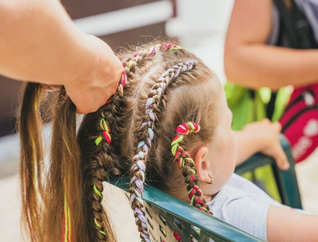 Girl with neat braided hairstyle ready for school in Dubai